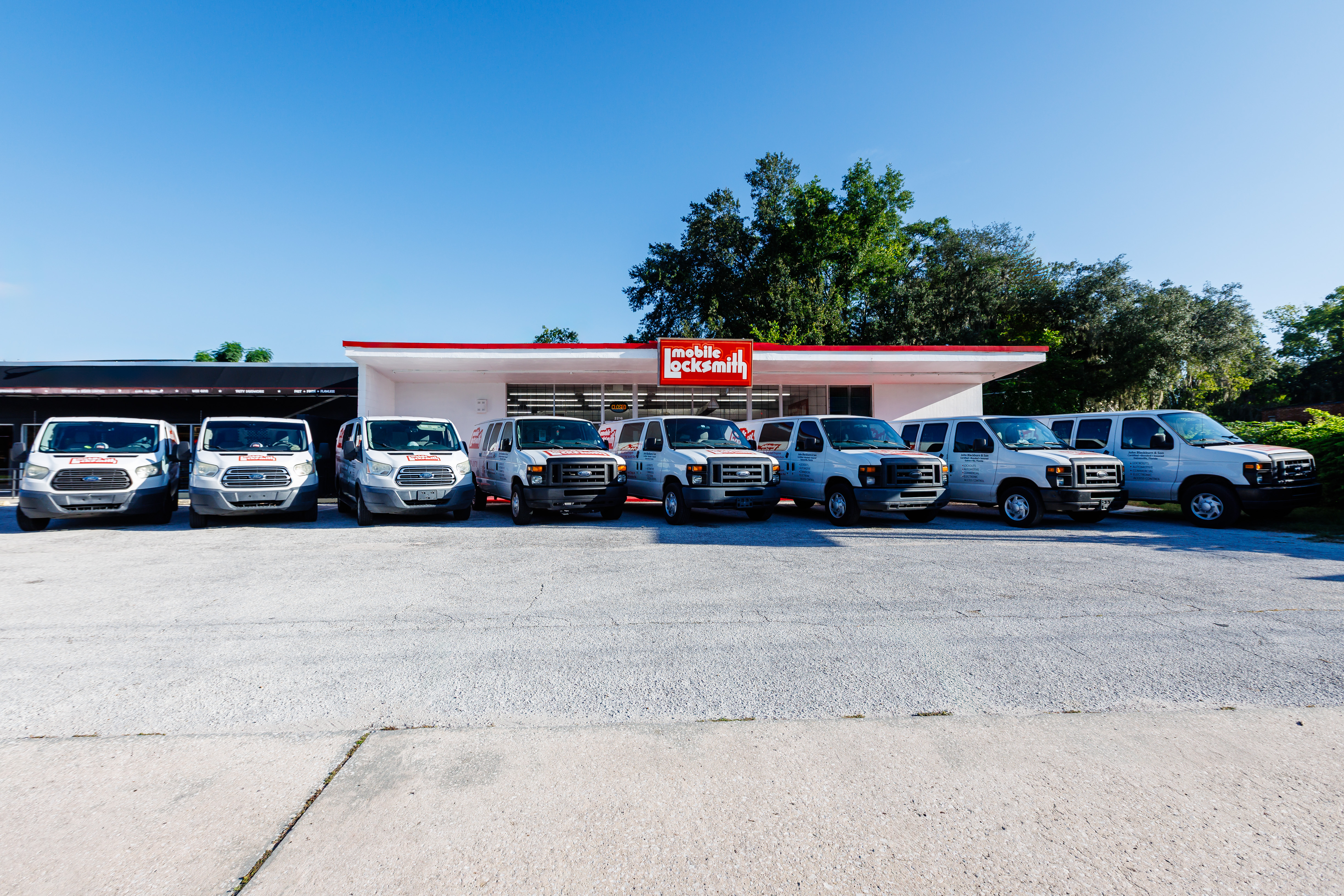 Mobile Locksmith service van fleet parked in front of the Gainesville storefront